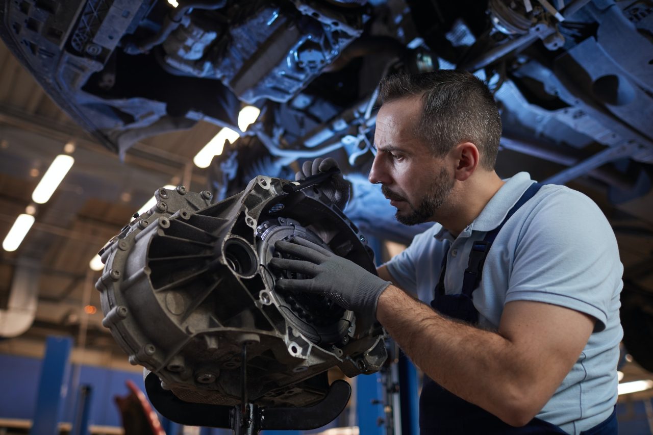 mechanic working on a car engine