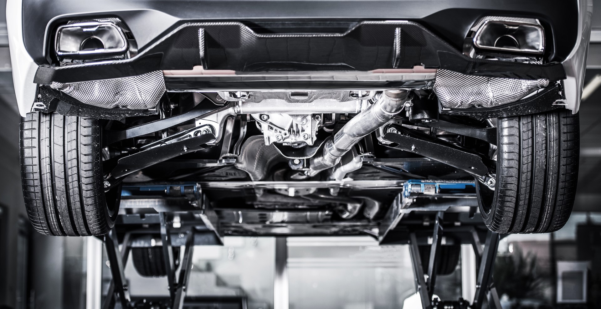 Car on a Vehicle Lift Inside the Auto Service Center. Panoramic Photo. Transportation Industry.