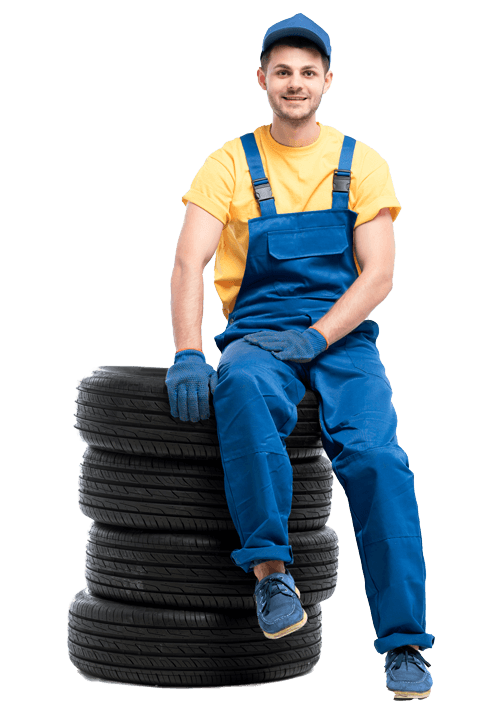 man sitting on a pile of tires