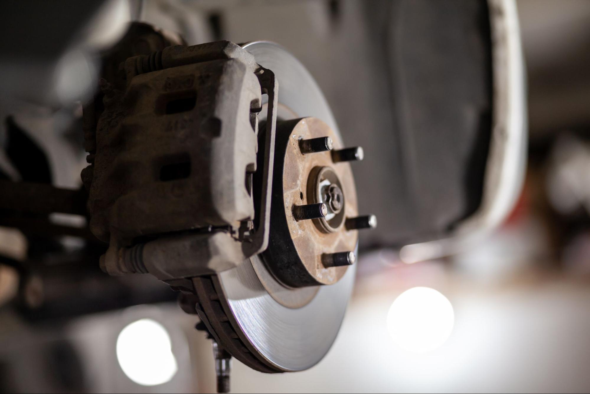 Close-up of a vehicle’s disc brake awaiting repair