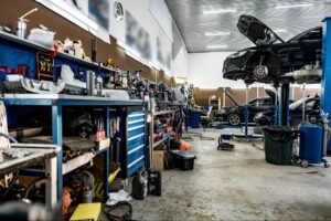 Auto shop with a car undergoing inspection and repair tools visible