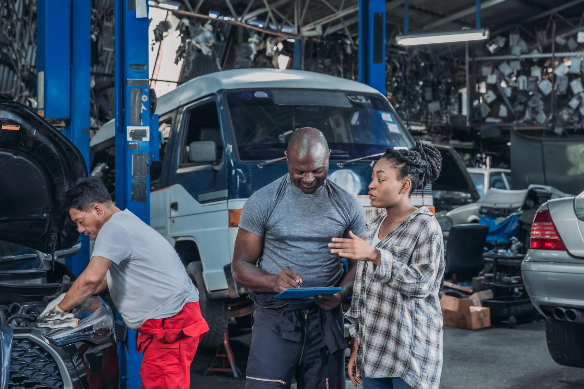 Auto shop technicians working together in a busy repair shop